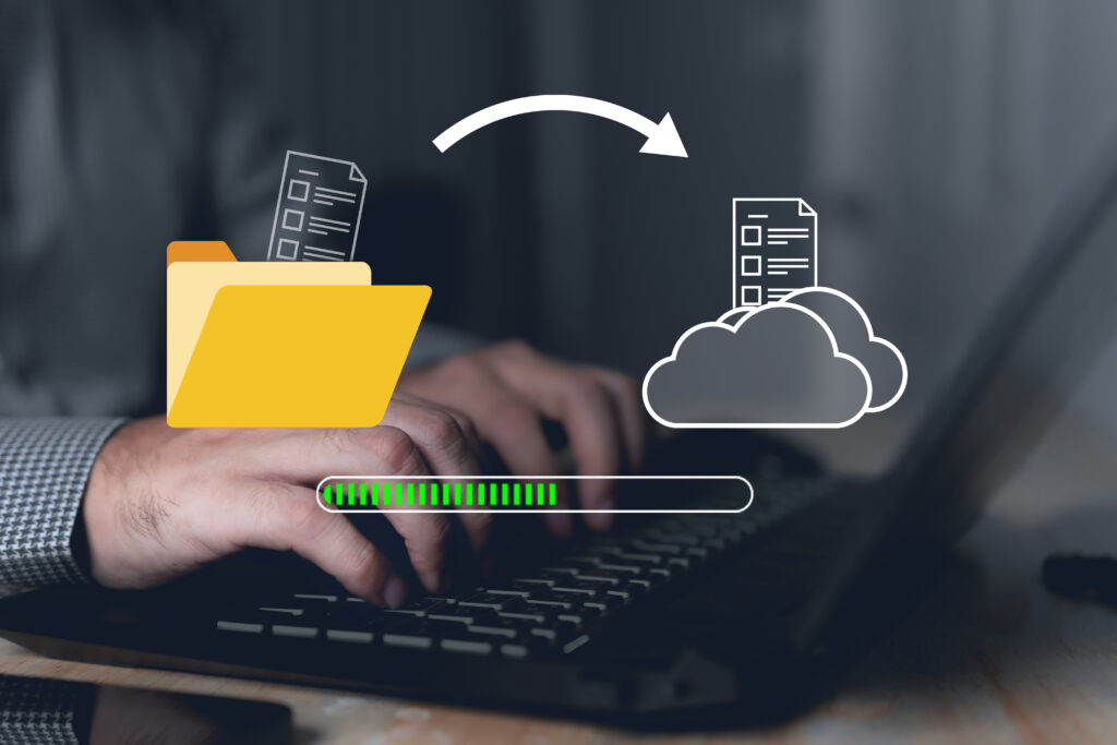 Illustration of file transfer from a folder to cloud storage over a laptop.