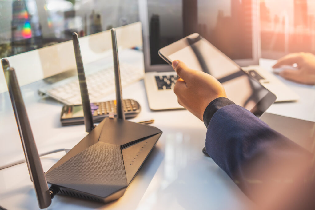 Wi-Fi router on an office desk with connected devices.