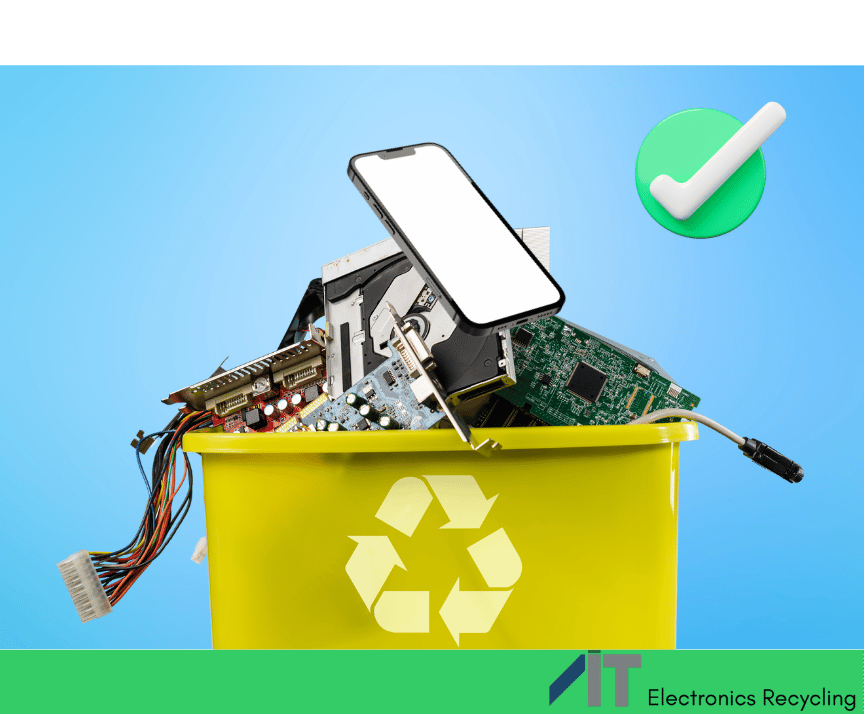 A mobile phone is on top of a heap of electronics inside of an recycling bin with a green check mark next to it.