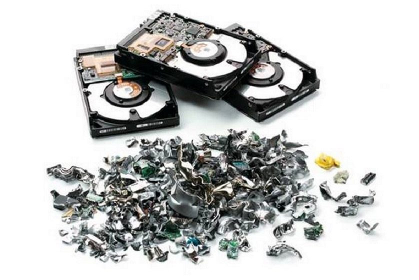 Three intact hard drives shown above a pile of shredded metal and electronic fragments on a white background, illustrating secure physical data destruction.