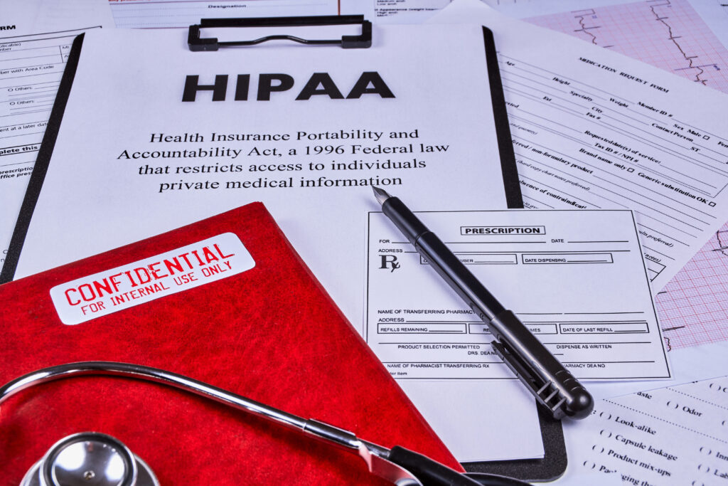 HIPAA document with confidential medical records, prescription forms, and a stethoscope on a desk, representing data destruction standards, patient privacy, and healthcare compliance.