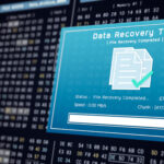 Computer screen displaying recovery software retrieving deleted files.