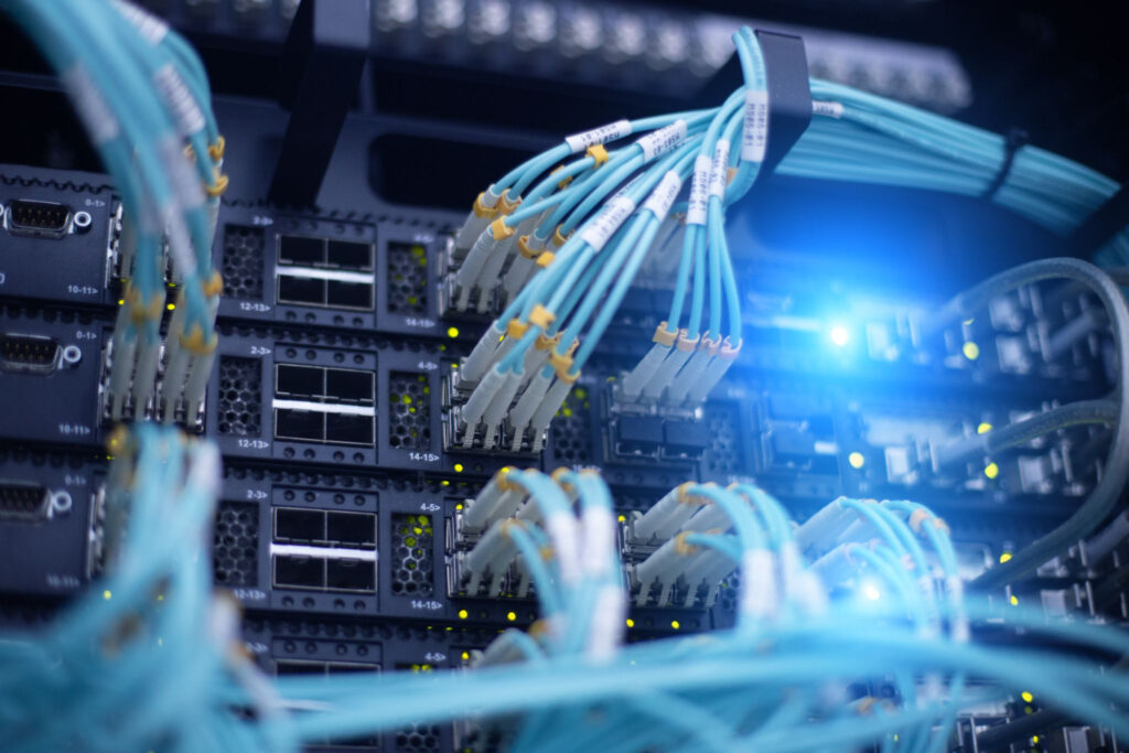 Close-up of fiber optic cables and network switches in a data center