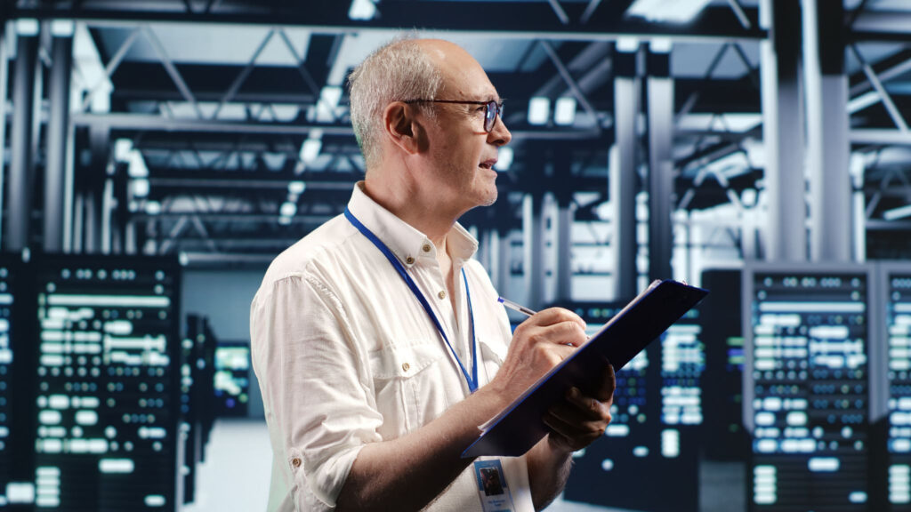IT professional with clipboard inspecting a modern data center