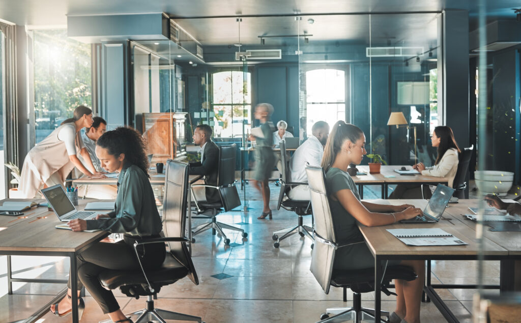 Professionals working in a modern office, representing organizational operations, internal controls, and the collaborative environment behind SOC 3 reporting and compliance.