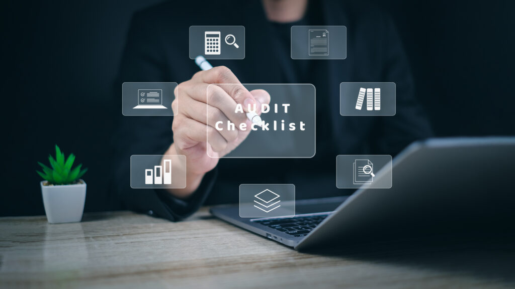 Professional using a digital audit checklist interface on a desk, representing SOC 3 reporting, compliance review, and security documentation.