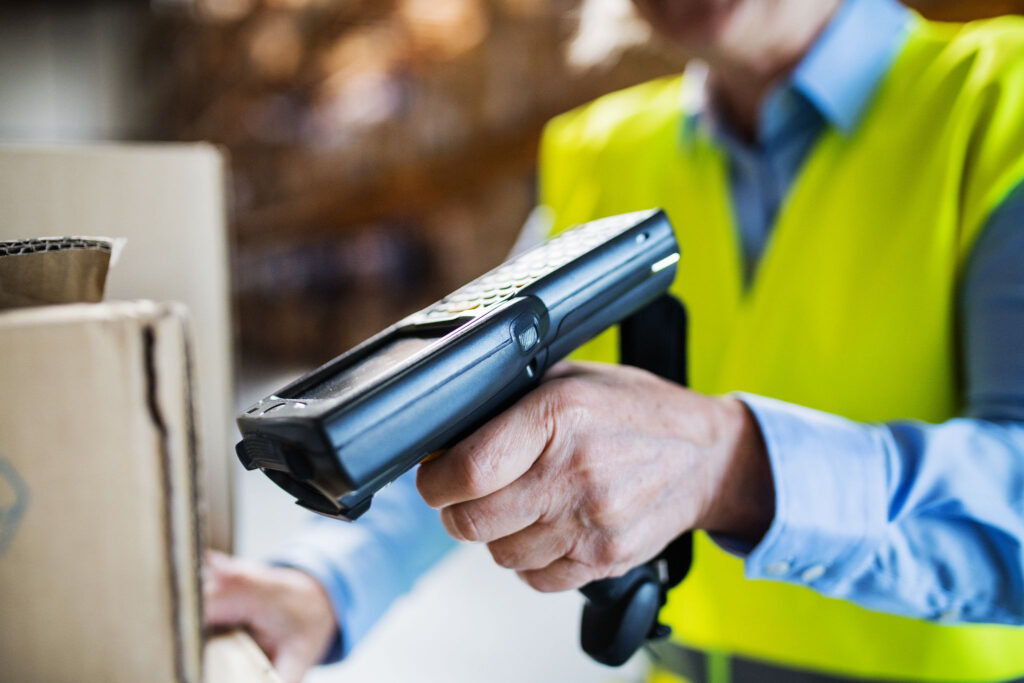 A warehouse worker scans a box